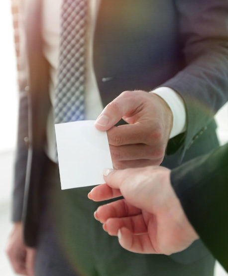Man handing a business card to a prospective client