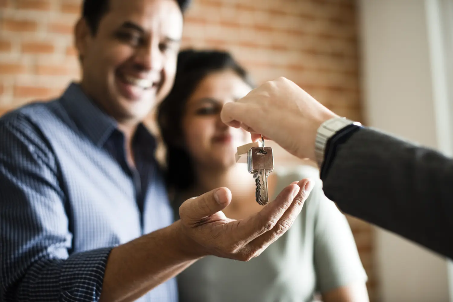 happy home buyers getting the keys to their new house