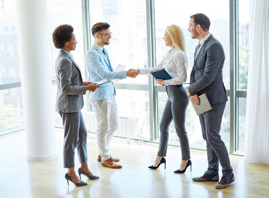 Real estate agents shaking hands after signing a contract