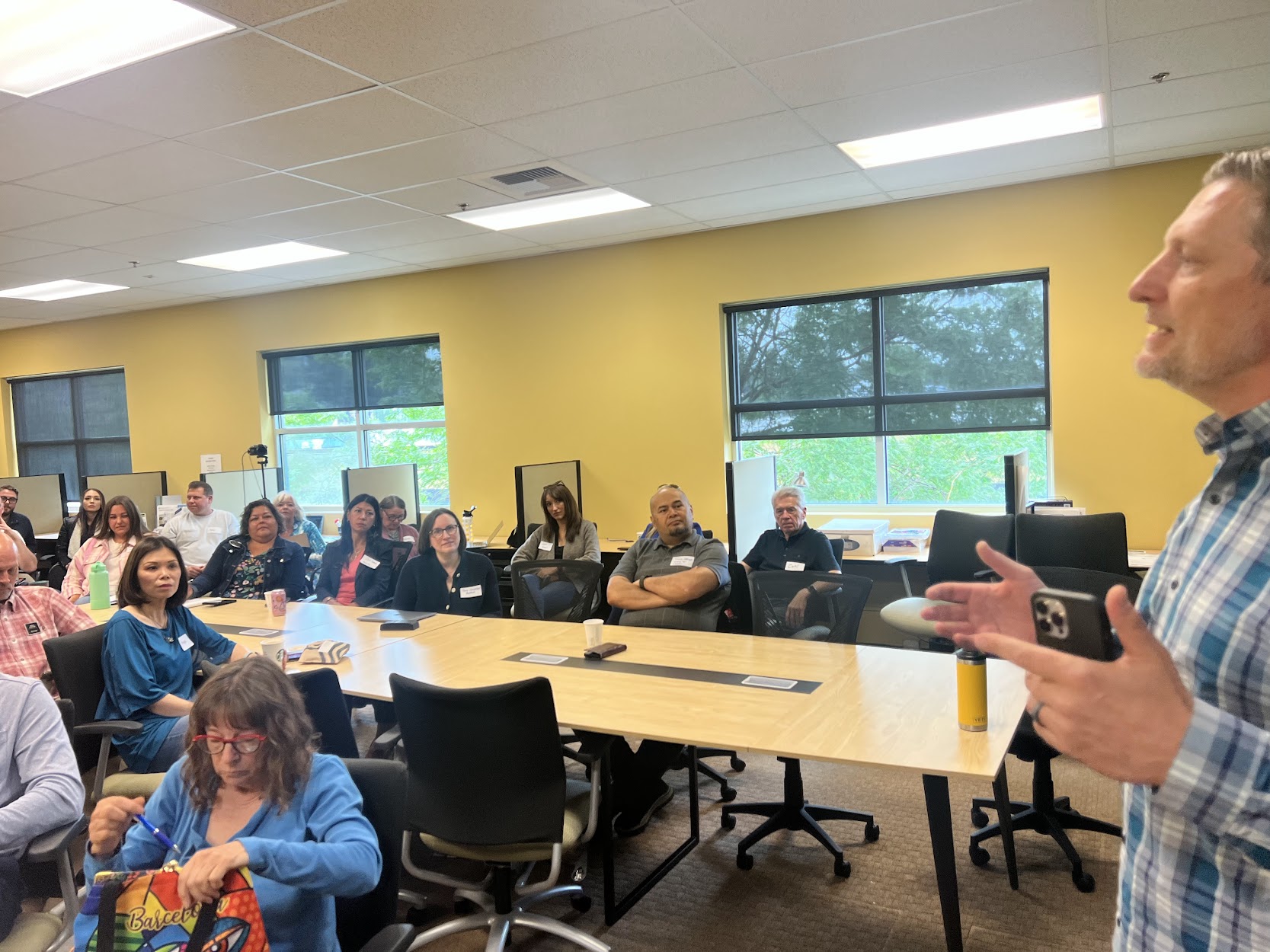 Jason Fox speaking with a group in a working session