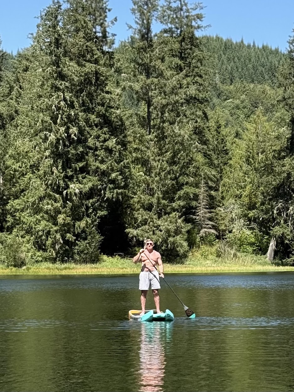 Jason Fox paddleboarding on Lake Tyee in the North Cascades.
