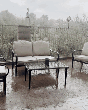 Rain falling across Jason’s Tucson patio during a monsoon storm